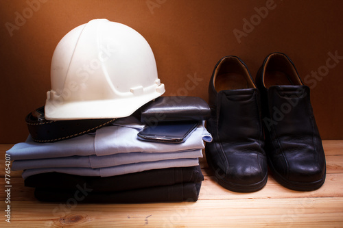 Workwear, boots and wallet and mobile.