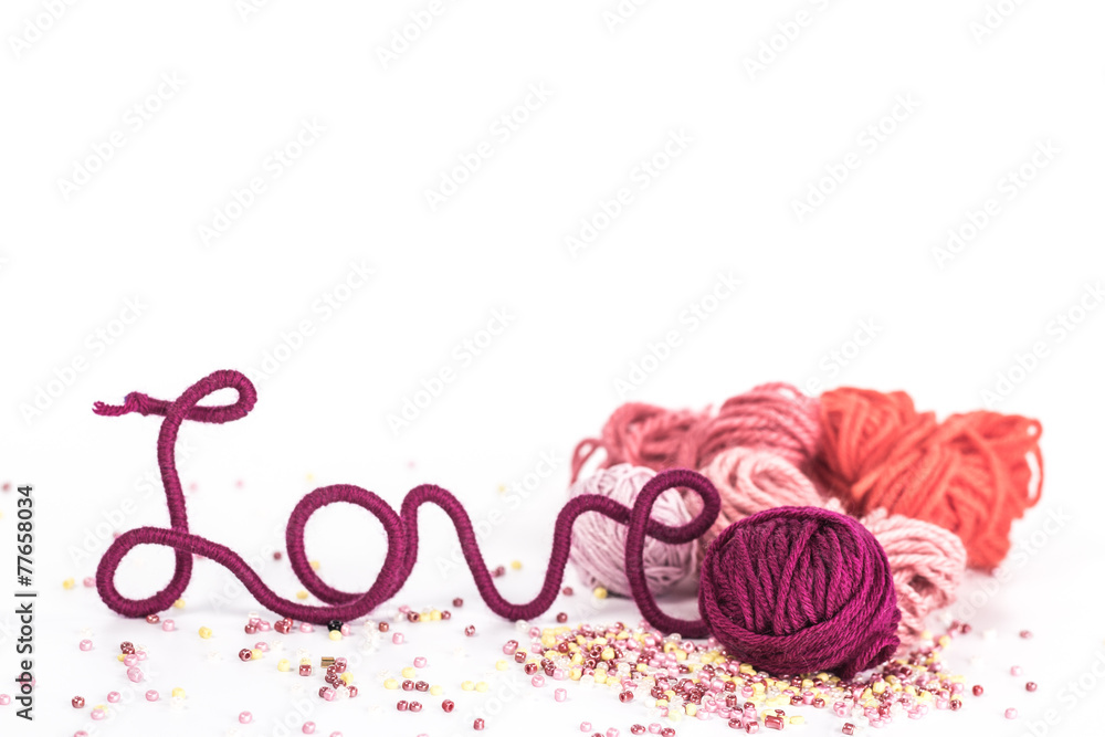 word love of red thread on background of wool ball