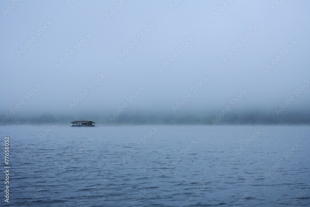 raft float on river among mist