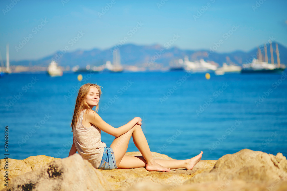 Beautiful girl enjoying her vacation by the sea