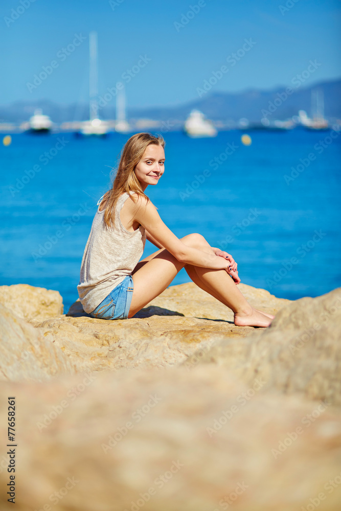 Beautiful girl enjoying her vacation by the sea