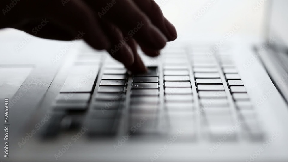 Fingers typing on a laptop Keyboard Fingers typing on a laptop Keyboard