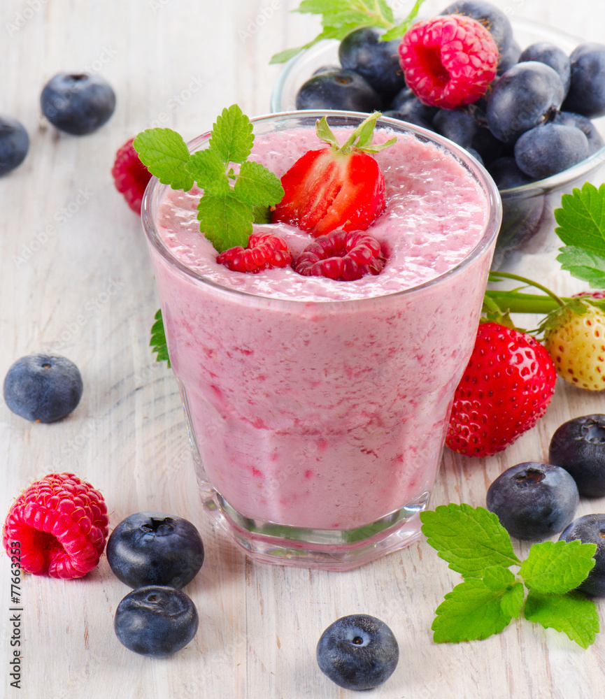 Raspberry smoothie with fresh berries on a wooden table . Raspberry smoothie with fresh berries on a wooden table .