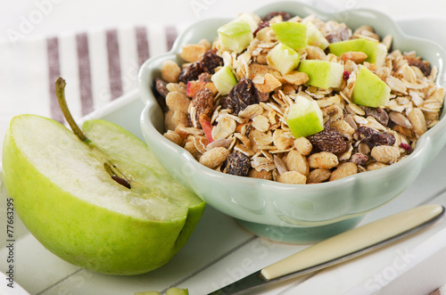 Healthy bowl of muesli and  apple for a nealthy breakfast photo