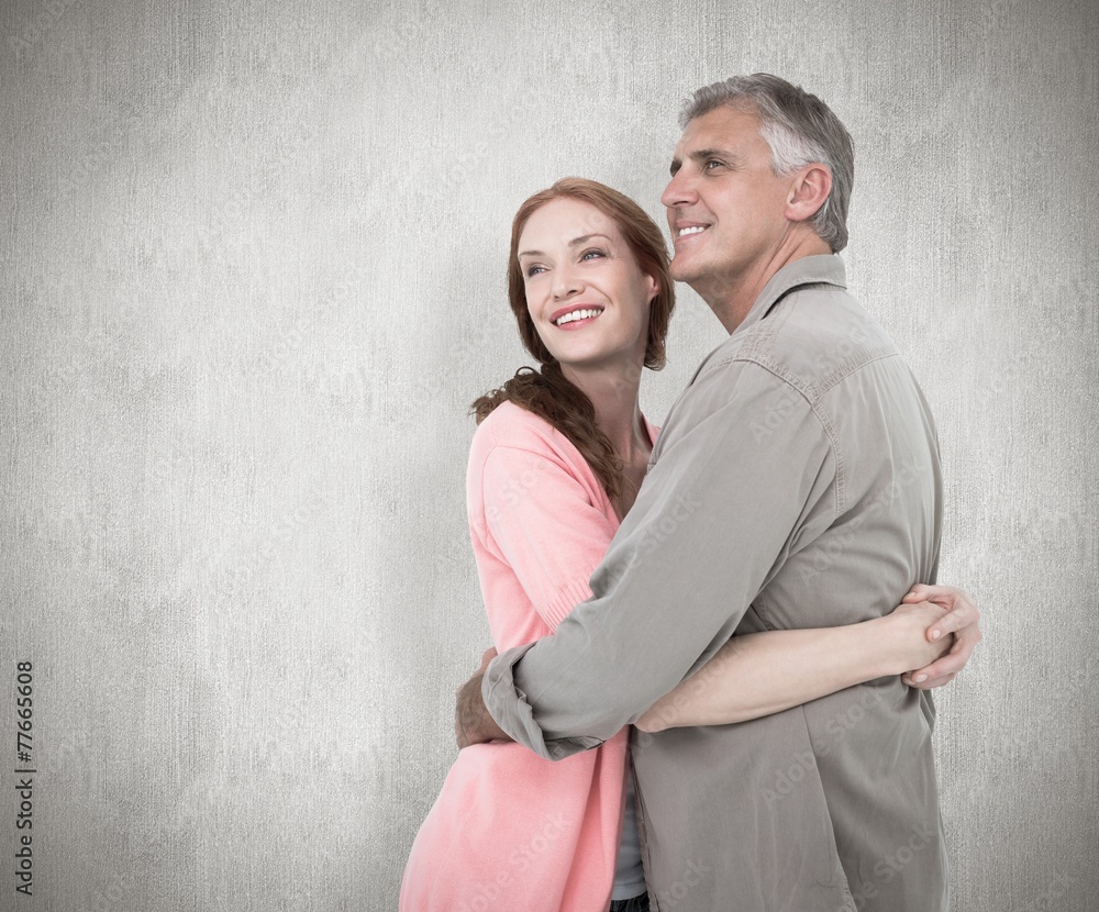 Composite image of casual couple hugging and smiling Composite image of casual couple hugging and smiling