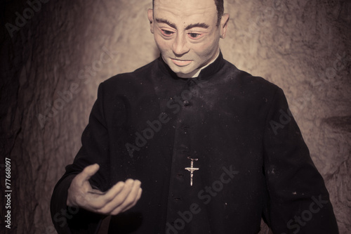 Close up Priest Statue in Black Attire
