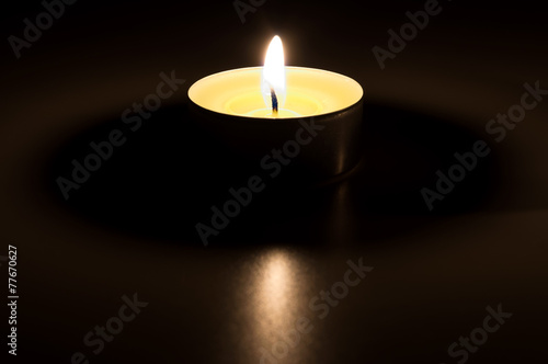 Burning candle in the dark