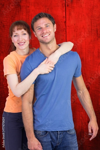 Composite image of happy couple looking at camera