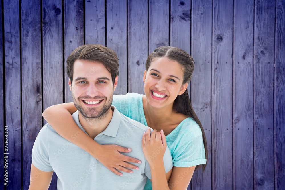 Composite image of cute couple smiling at camera Composite image of cute couple smiling at camera