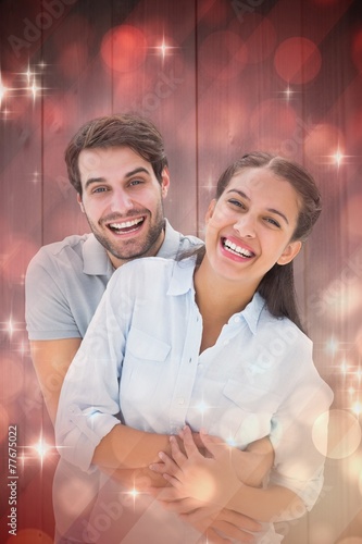 Composite image of cute couple hugging and smiling at camera