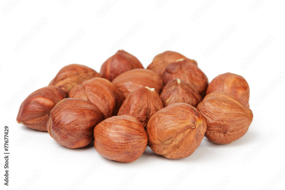 Heap of peeled hazelnuts isolated on white Heap of peeled hazelnuts isolated on white