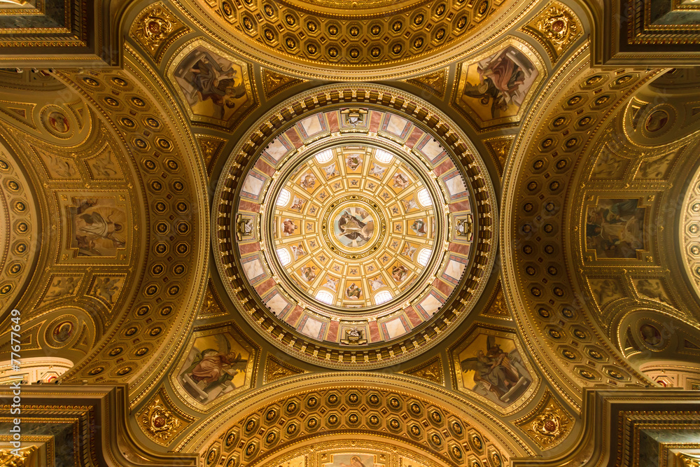 The golden dome and interior inside the church in Budapest