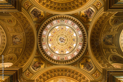 The golden dome and interior inside the church in Budapest