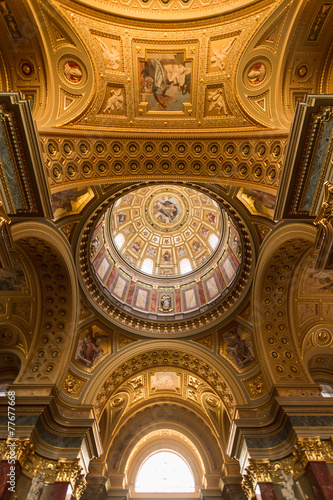 The golden dome and interior inside the church in Budapest