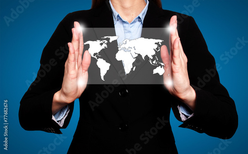 Businesswoman in dark suit holds world map global communication