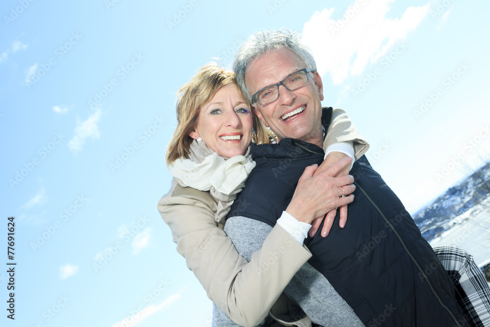 Portrait of happy senior couple in winter season - obrazy, fototapety, plakaty 