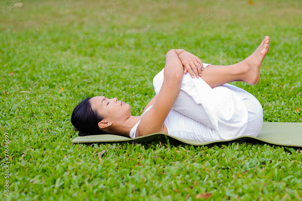 Beautiful woman practicing yoga in the park Beautiful woman practicing yoga in the park