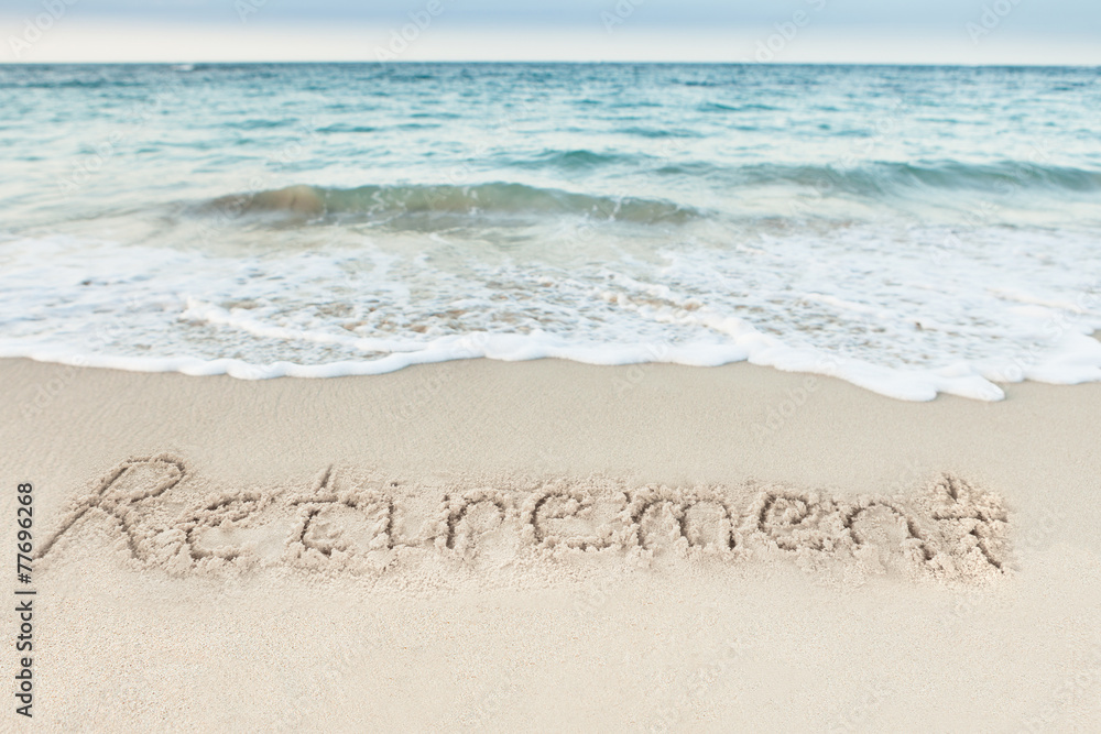 Fototapeta premium Retirement Written On Sand By Sea