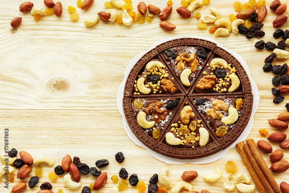 Dessert chocolate pizza with raisins and nuts