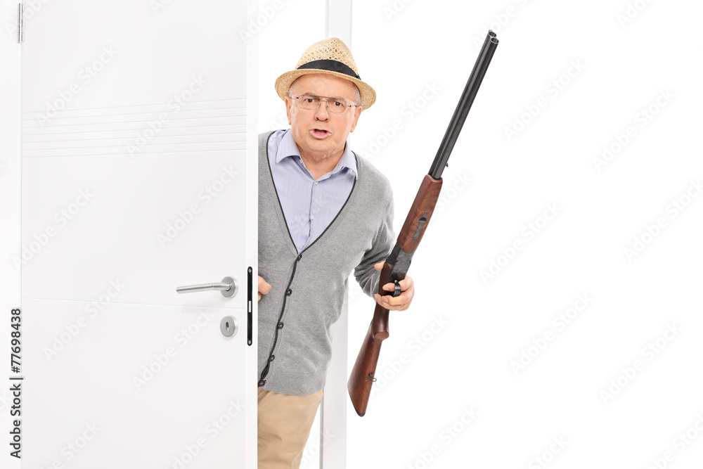 Senior with rifle bursting through a door Senior with rifle bursting through a door