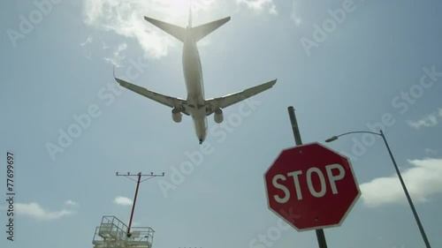 airplane flying overhead - plane in sky over highway with cars driving - landing in LAX airport in 4K and 1080 HD