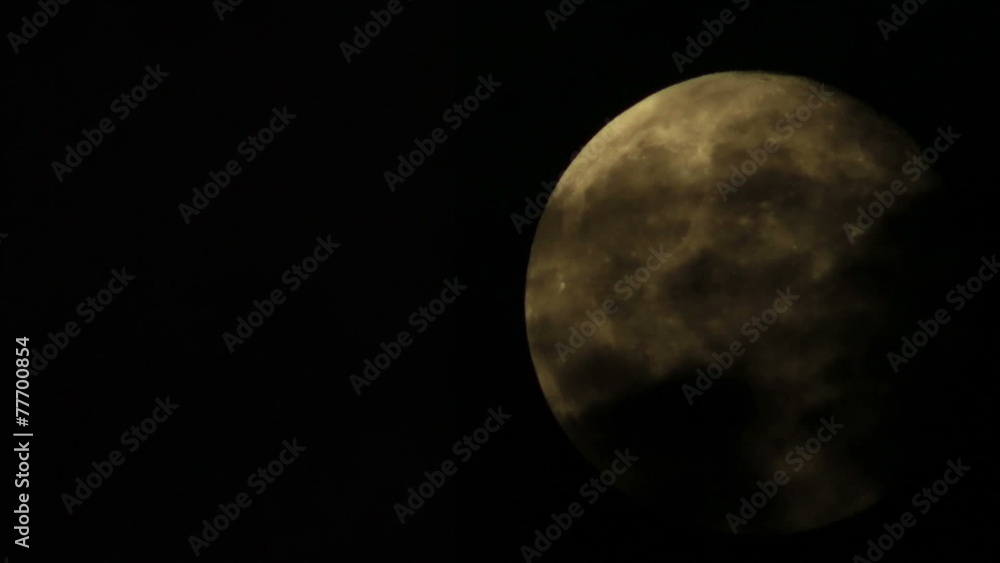 A bright full moon time lapse in darkness with clouds passing A bright full moon time lapse in darkness with clouds passing