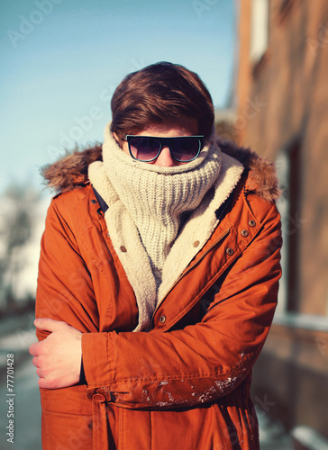 stylish hipster man freezes in the city