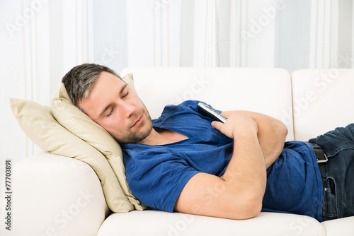 Tableau sur toile Man Sleeping On Couch