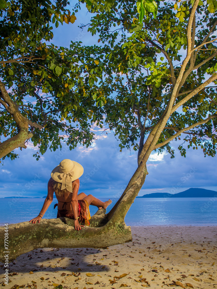 Woman in sarong on a tree