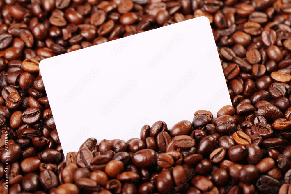 Against the backdrop of coffee beans is a business card Against the backdrop of coffee beans is a business card