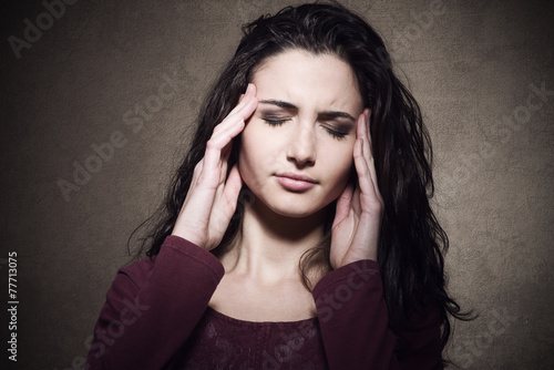 Tired young woman with headache