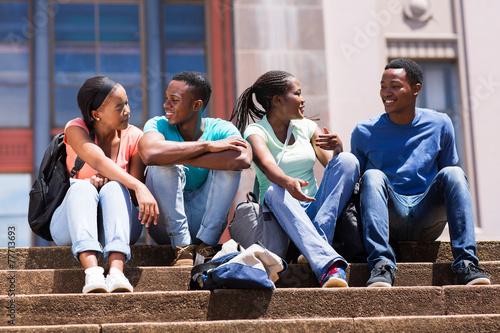 group of african american college friends sitting on stairs