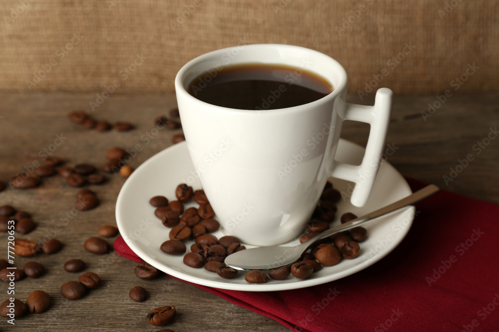Cup of coffee with beans on rustic wooden background Cup of coffee with beans on rustic wooden background