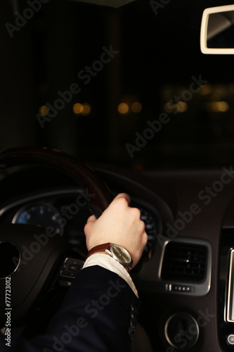 Man driving his modern car at night in city, close-up © Africa Studio