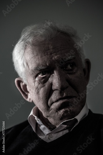 Old depressed man crying