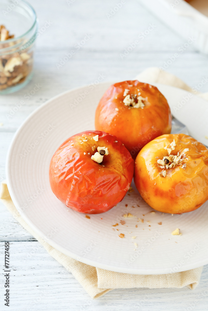 Apples baked in a plate on white napkin Apples baked in a plate on white napkin