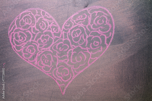 Hand drawn pink hearts on chalkboard background.