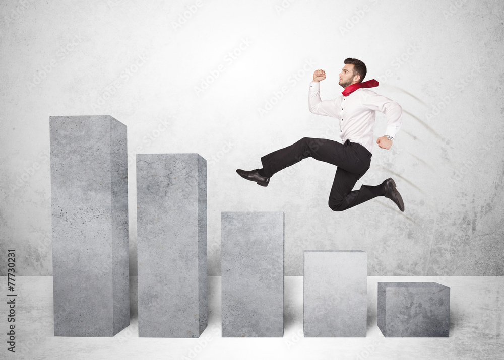Successful business man jumping over charts on background Successful business man jumping over charts on background