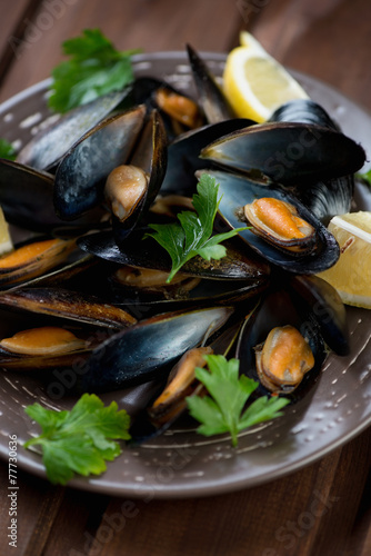 Steamed mussels with lemon and parsley, selective focus