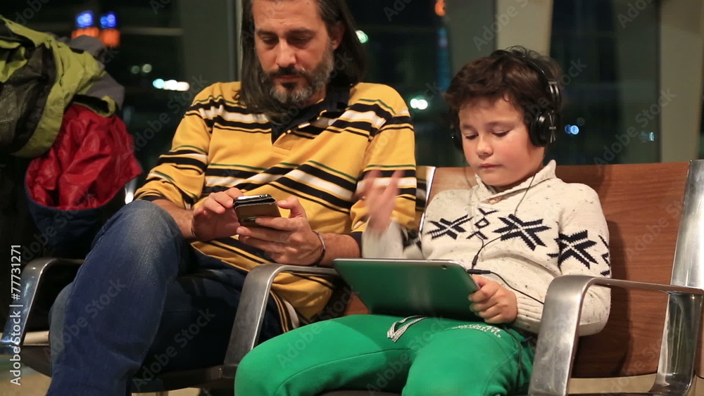 Father and son waiting at the airport Father and son waiting at the airport