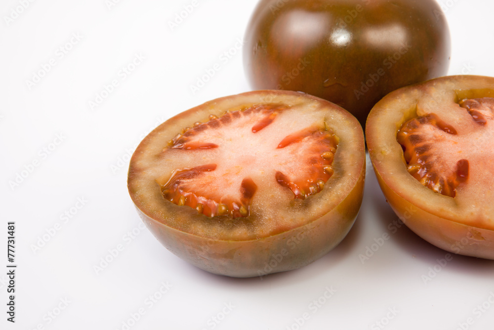 Whole and sliced kumato tomatoes