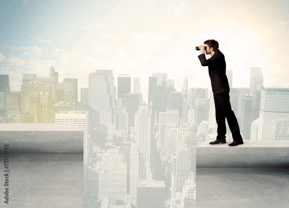 Businessman standing on the edge of rooftop Businessman standing on the edge of rooftop