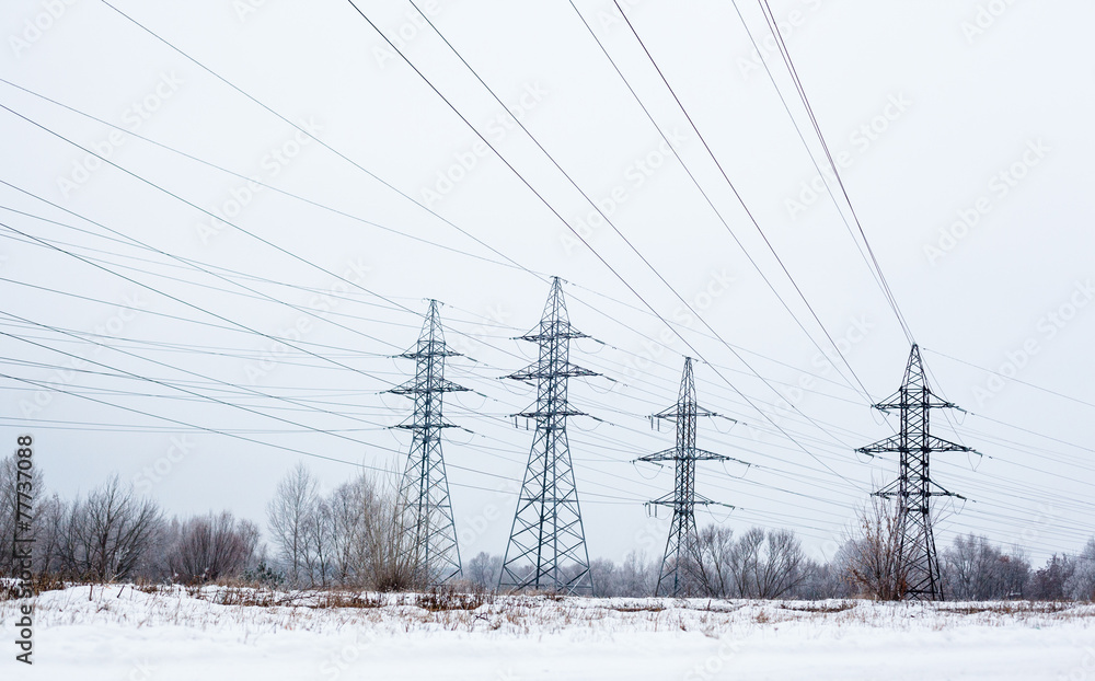 Electricity pylons and power lines in the winter day Electricity pylons and power lines in the winter day