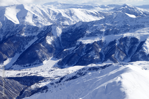 Top view on snowy mountains and off-piste slope © BSANI