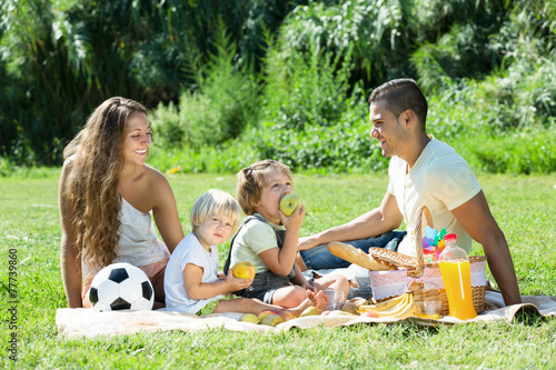  family with little children having picnic