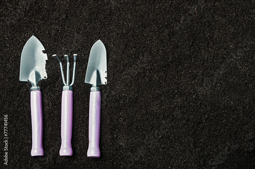 Gardening tools on a background of the soil
