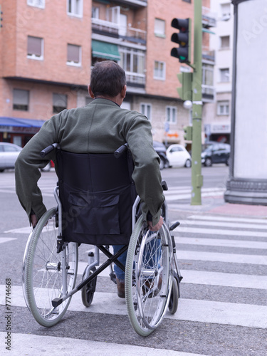 Man in wheelchair crossing a zebra © fresnel6