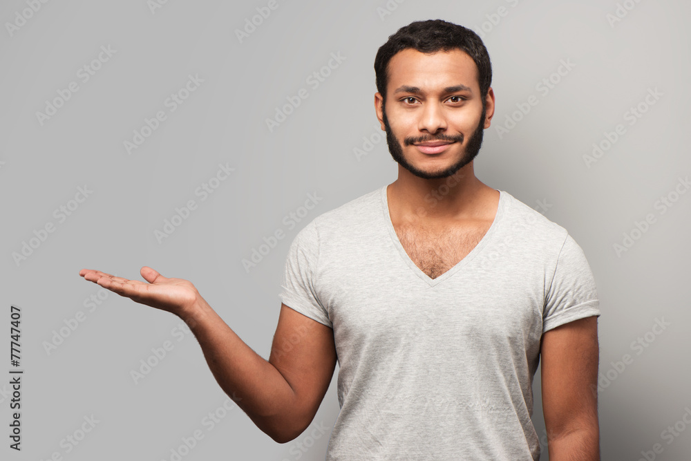 Smiling mixed race man pointing aside Smiling mixed race man pointing aside
