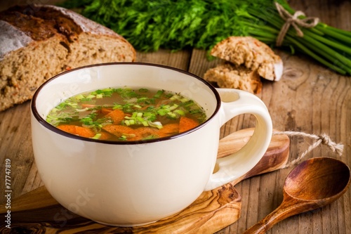 vegetable soup in a cup on a wooden background