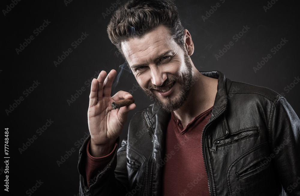 Confident fashionable man with cigar Confident fashionable man with cigar